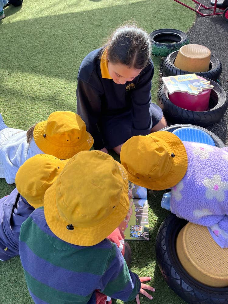 Year 5 students reading to preschoolers